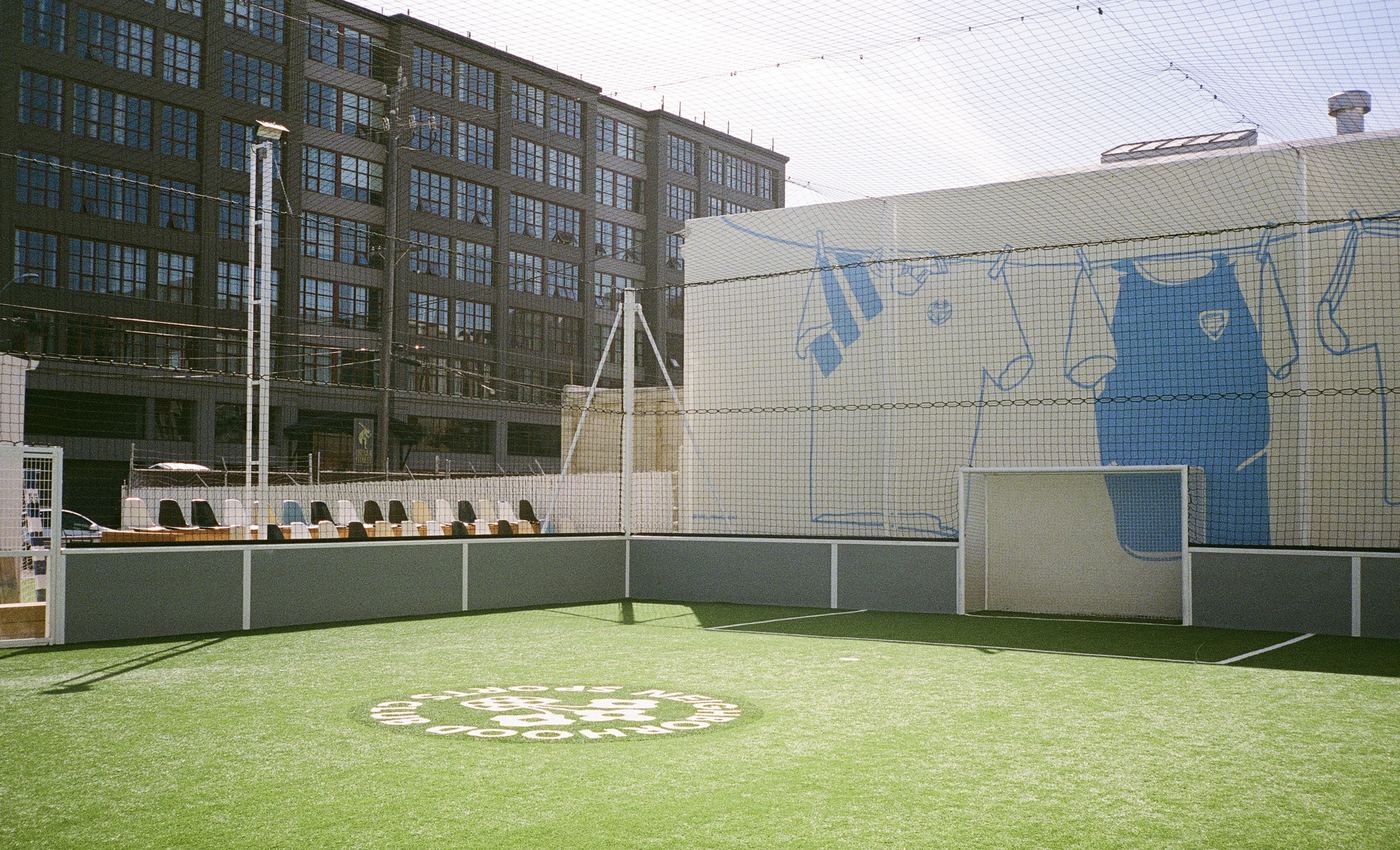 The NSC 5-a-side pitch in Oakland, with the club logo at center circle